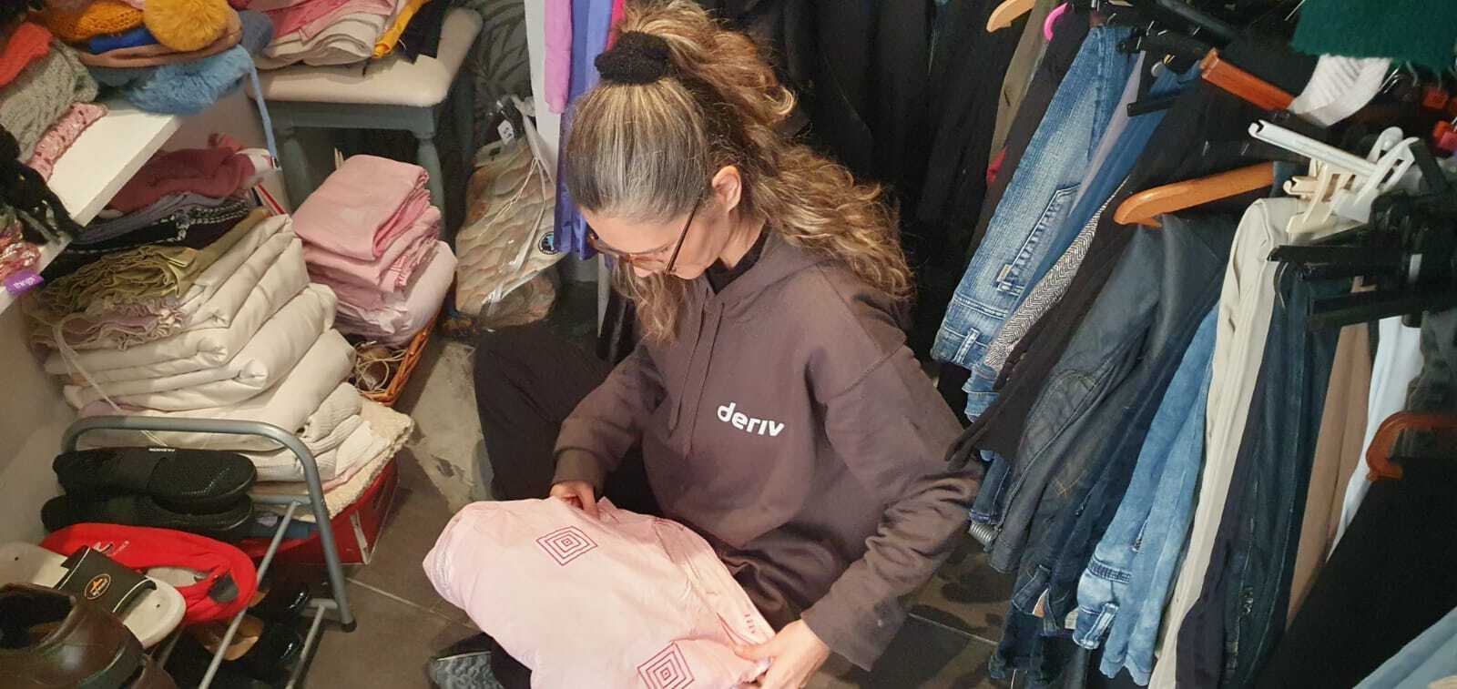 A Deriv volunteer in Puttinu Cares charity shop in Gzira, Malta