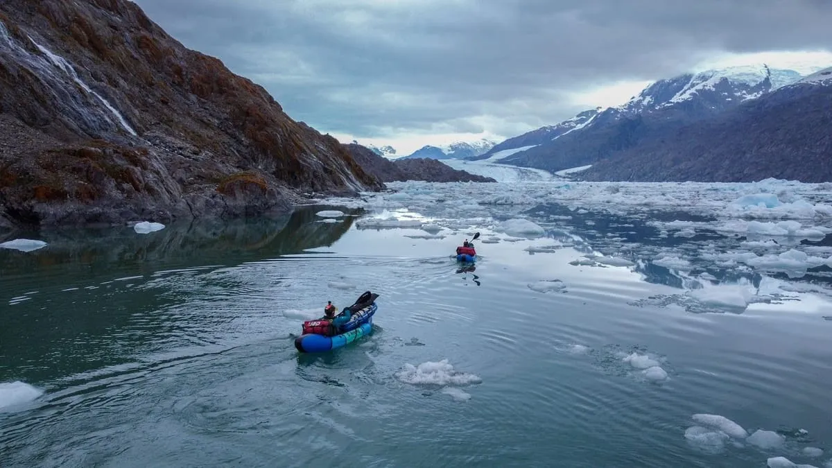 Two Kahuna team members rowing across an icy lake