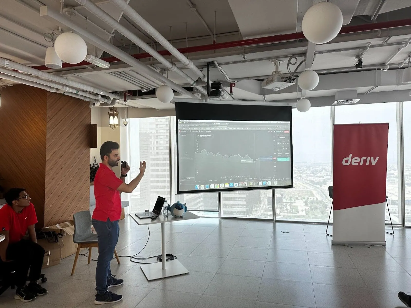A Deriv mobile app expert giving a presentation.