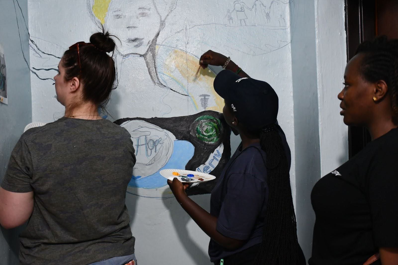 Deriv Rwanda employees and an employee from DuHope painting workshop for the Rwanda Africa CSR program