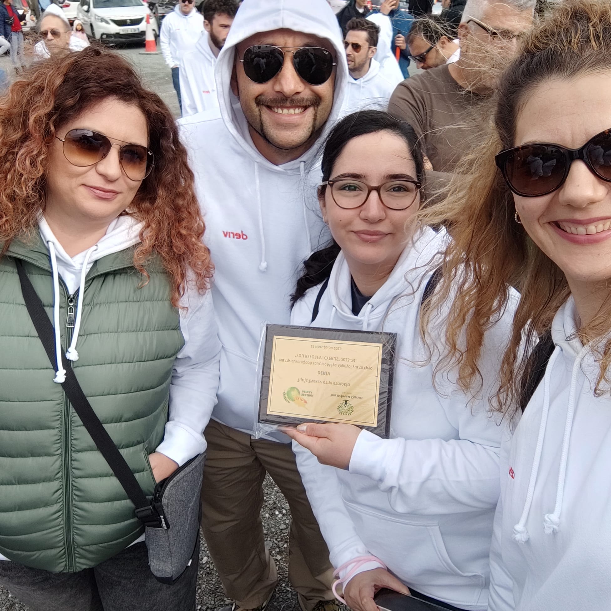 Deriv employees receiving a certificate of participation for the You Reforest Cyprus programme.