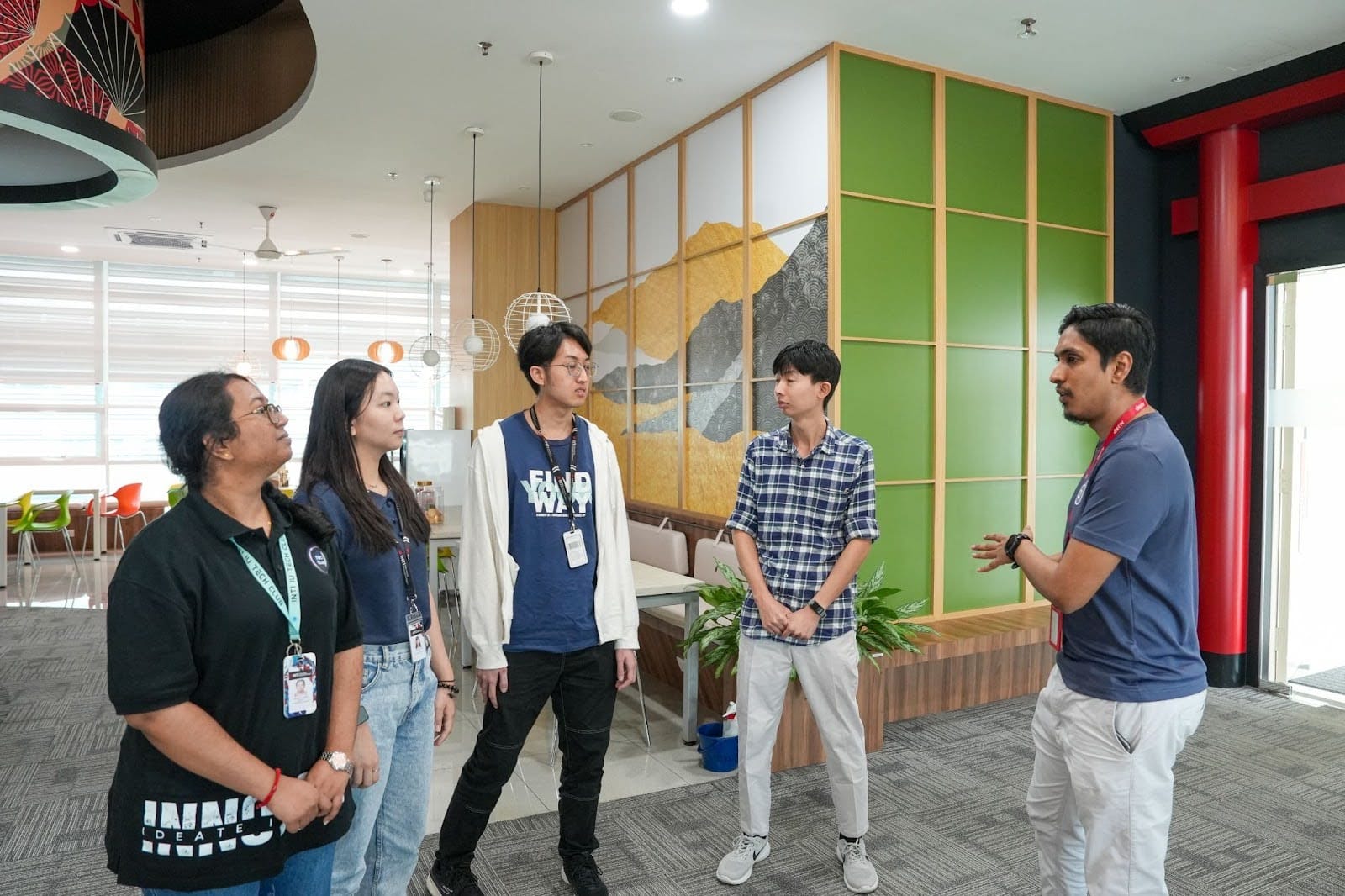 A Deriv team member giving an office tour to members of INTI’s IT Society.